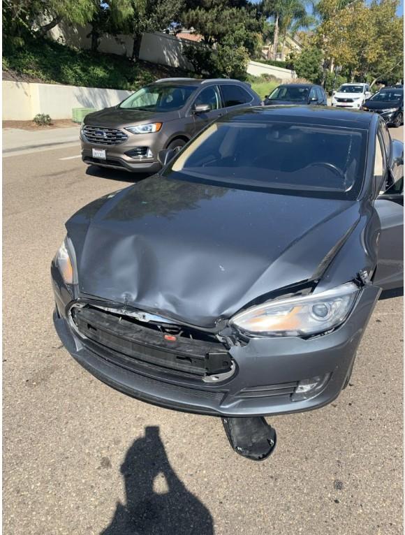 The damaged front end of Wayne Partello's Tesla parked on the street after the accident.