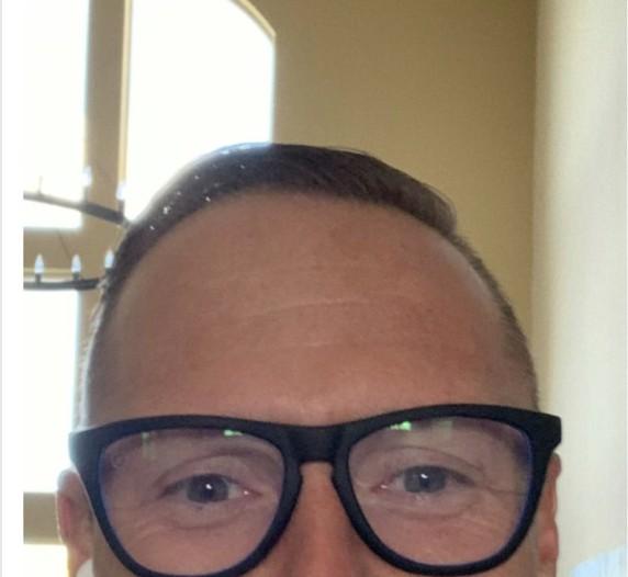 Close-up selfie of Wayne Partello wearing round black-framed glasses.