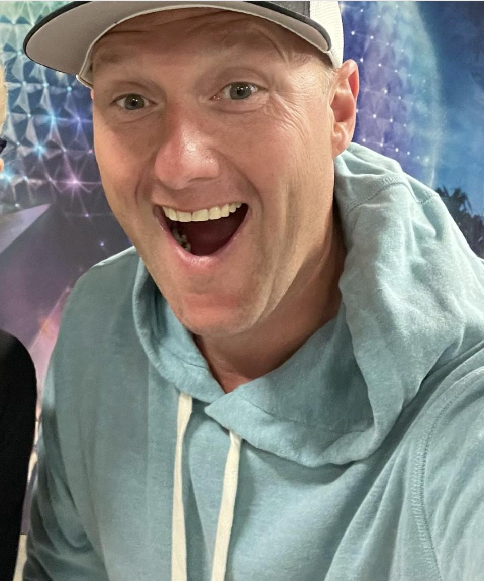 Wayne Partello takes an excited selfie in front of Epcot's Spaceship Earth at Disney World.