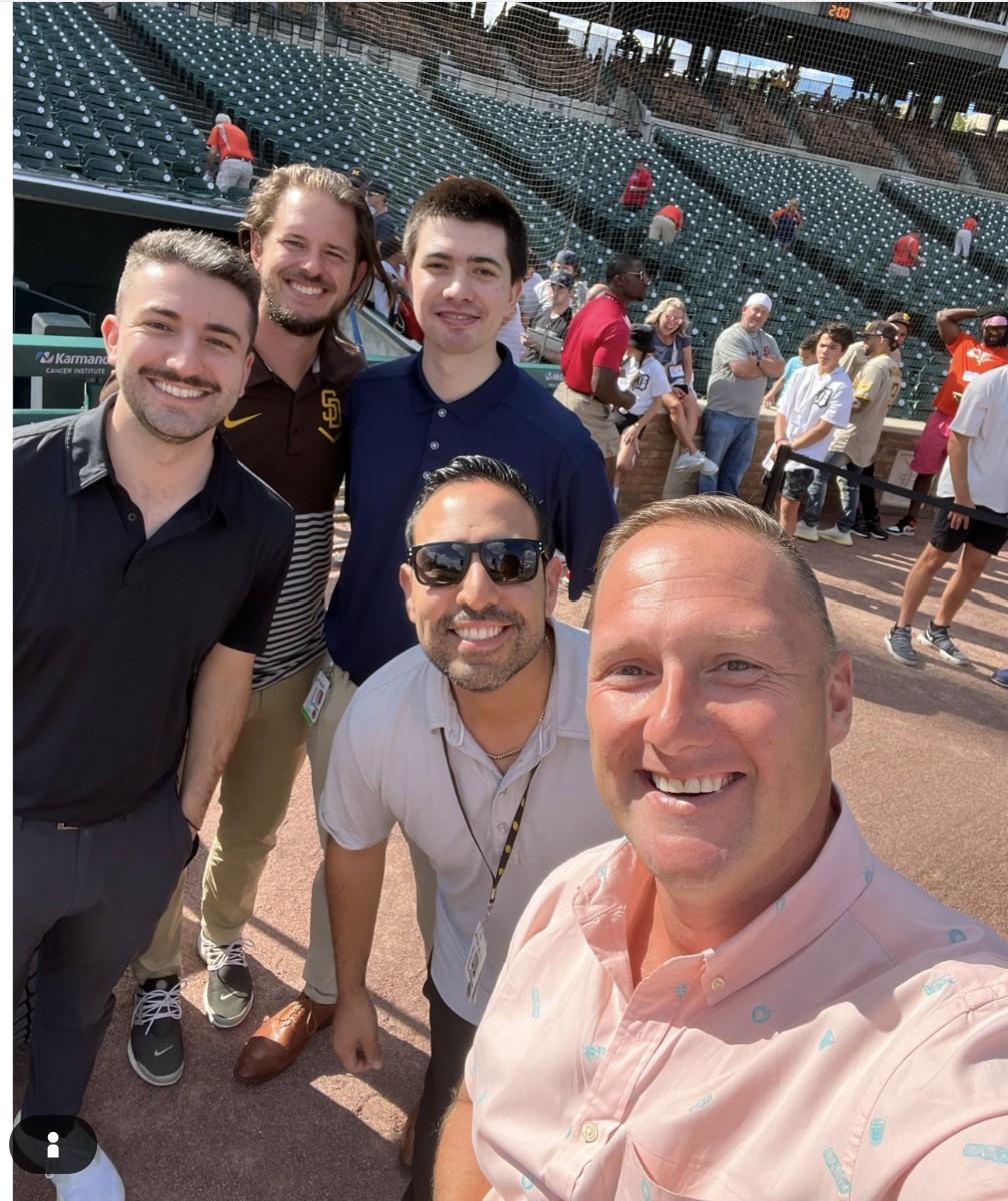 Wayne Partello takes a selfie with four former San Diego Padres colleagues on the field at Petco Park.