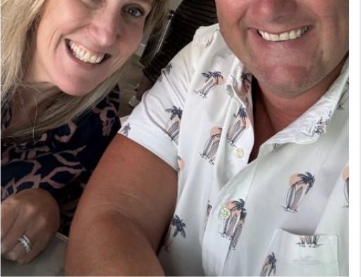 Wayne Partello taking a selfie with a colleague, both smiling