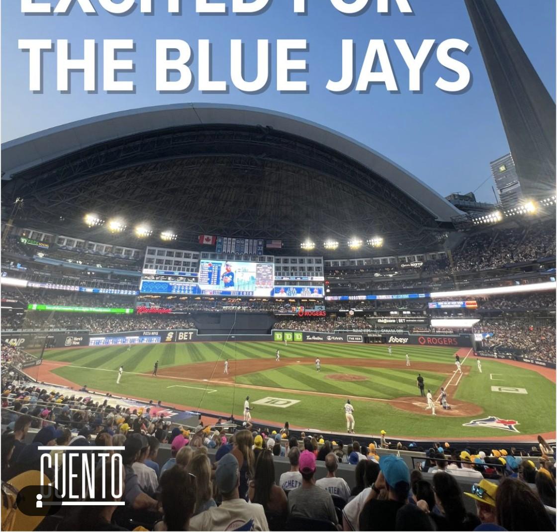 Wide view of Rogers Centre during a Toronto Blue Jays game, with the CN Tower visible above the retractable roof, captioned 'I'm So Excited for the Blue Jays.'